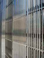 The new 7 WTC has a curtain wall with stainless steel louvers reminiscent of its predecessors.
